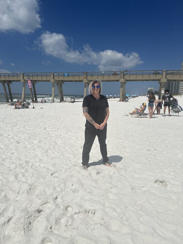 a woman standing on a beach